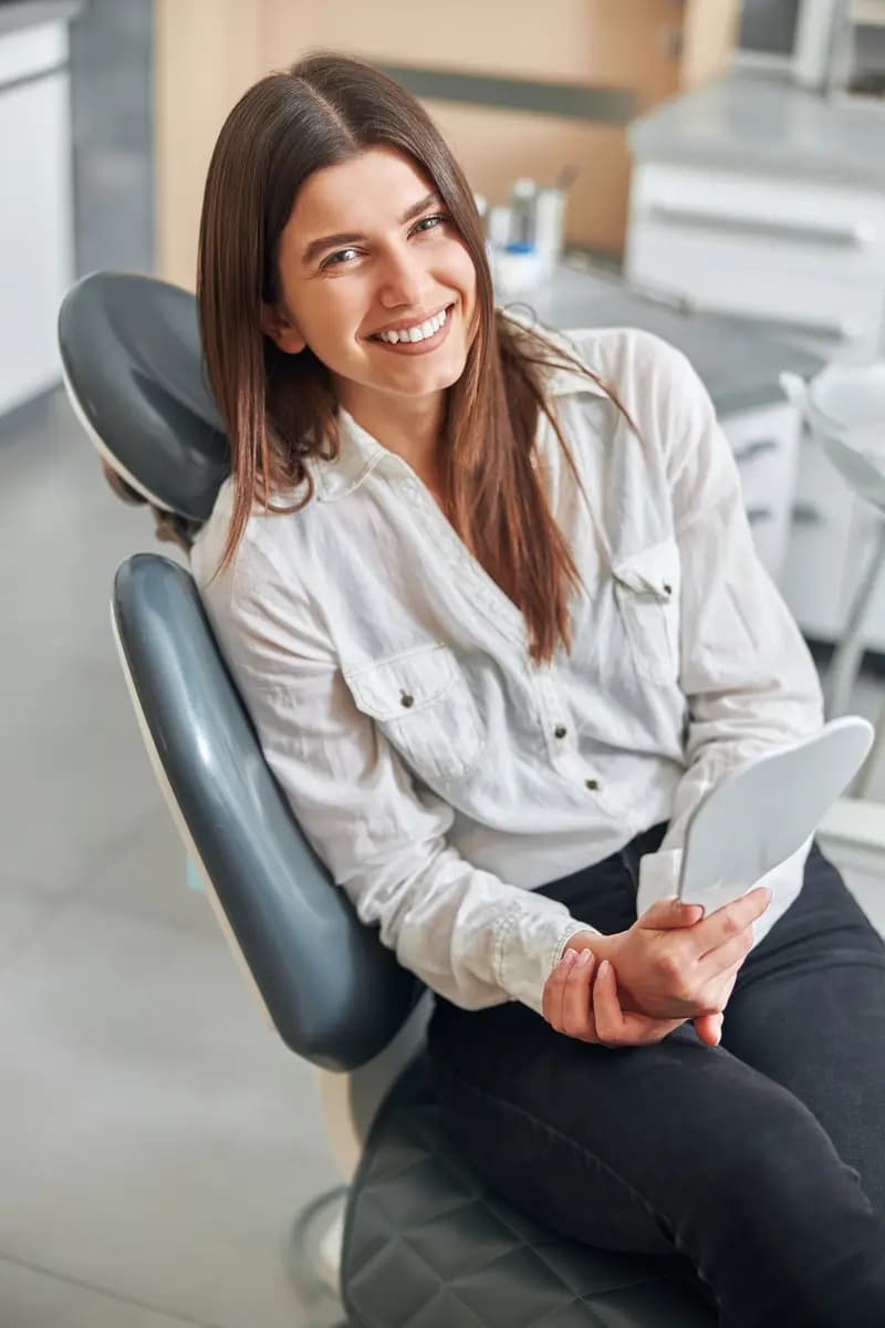 A happy patient smiling in the dental chair